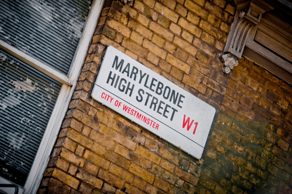 Marylebone High Street W1 City of Westminster street sign mounted on aged yellow London brick