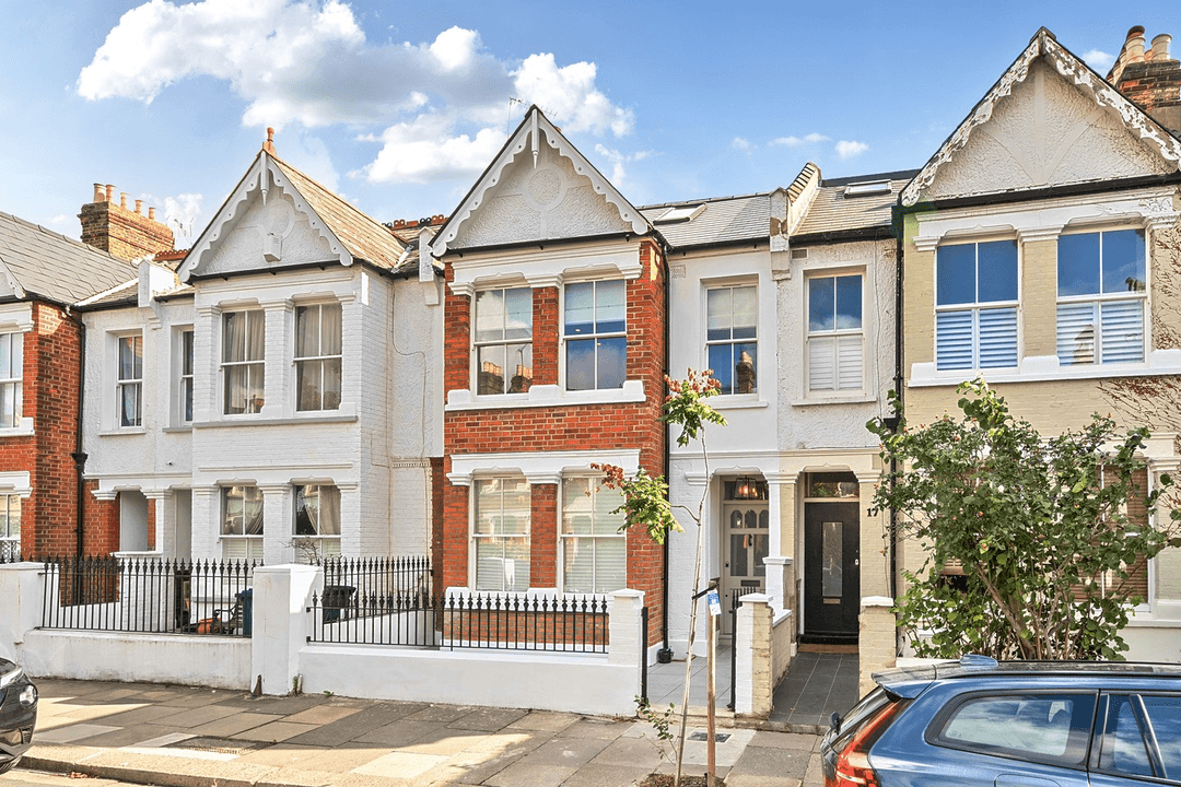 Shepherd's Bush terraced houses with white and brick facades under a partly cloudy sky