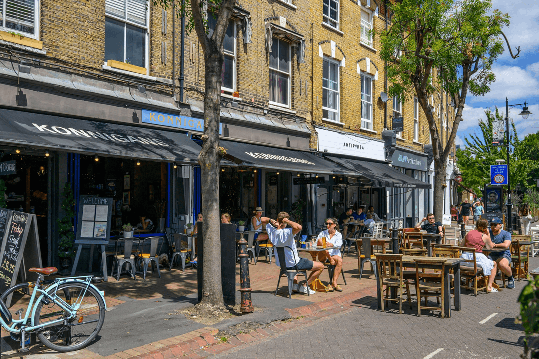 Wandsworth street with busy outdoor cafe seating and diners on a sunny summer afternoon